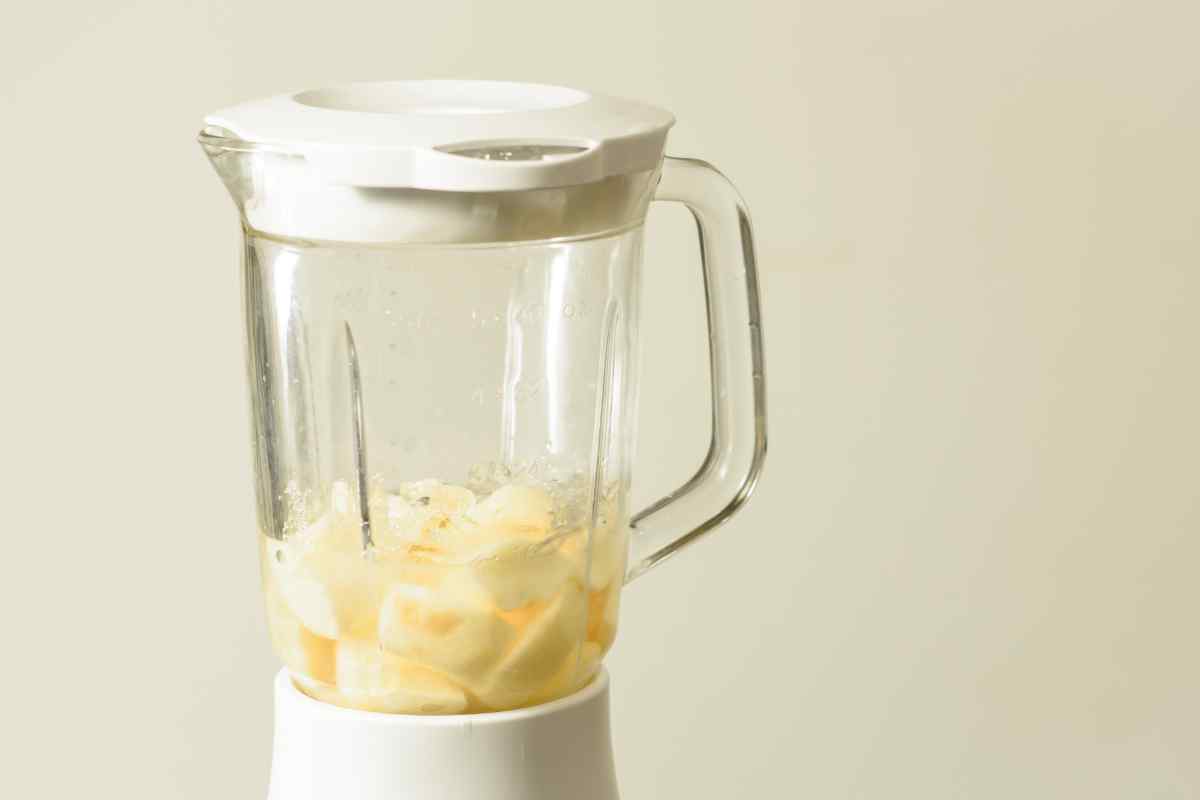 Image of a blender with chopped pears in it ready to blend, this is part of a blog about making pear and coconut milkshake with kids