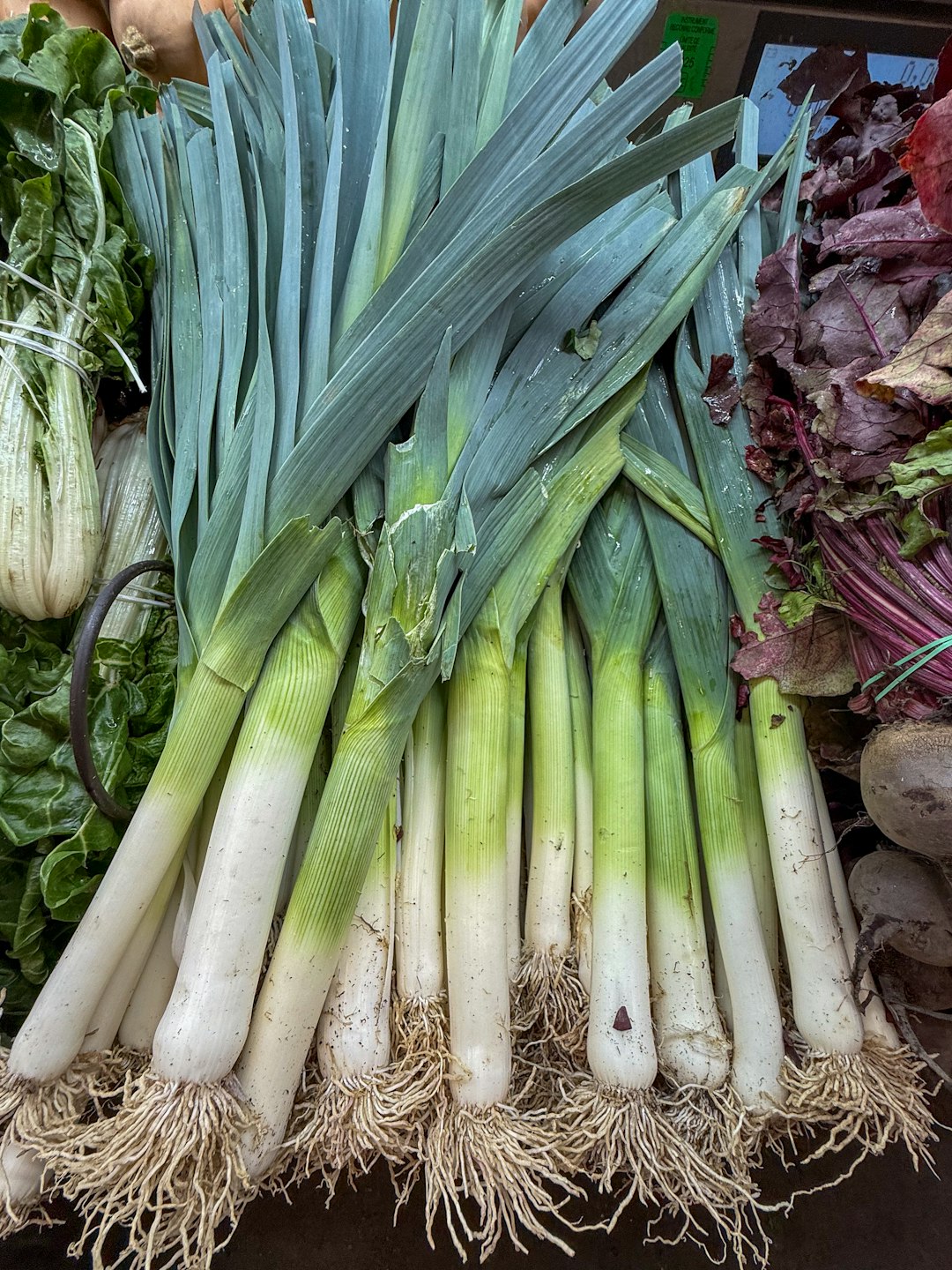 Fresh leeks are on display at a market.