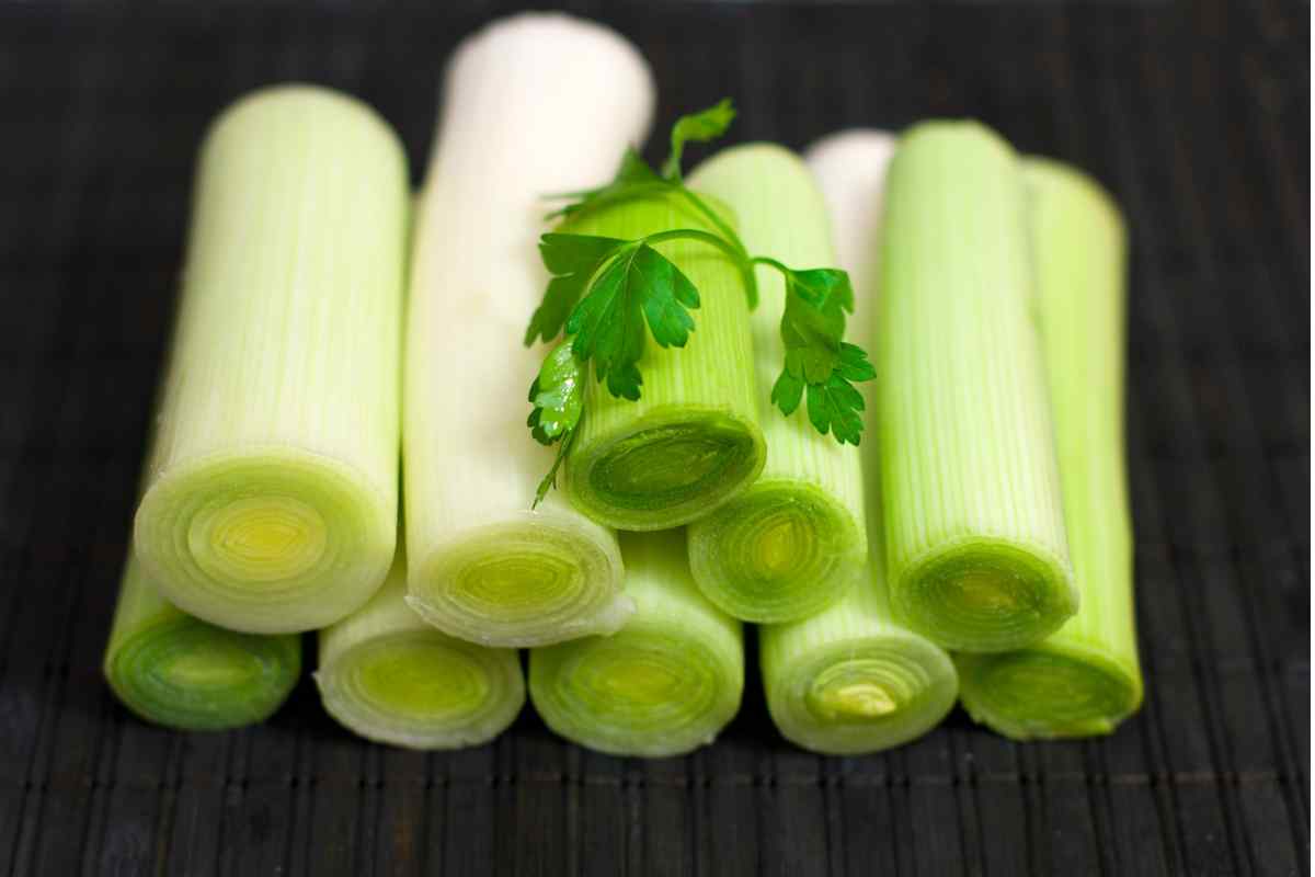 Image of some leeks with ends removed and chopped into half lengths, this is part of a blog about making a leek and cheese pasta recipe with kids