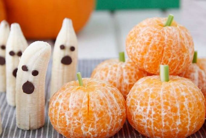 novelty food image of banana choc chip ghosts and peeled tangerines made to look like pumpkins from Weelicious