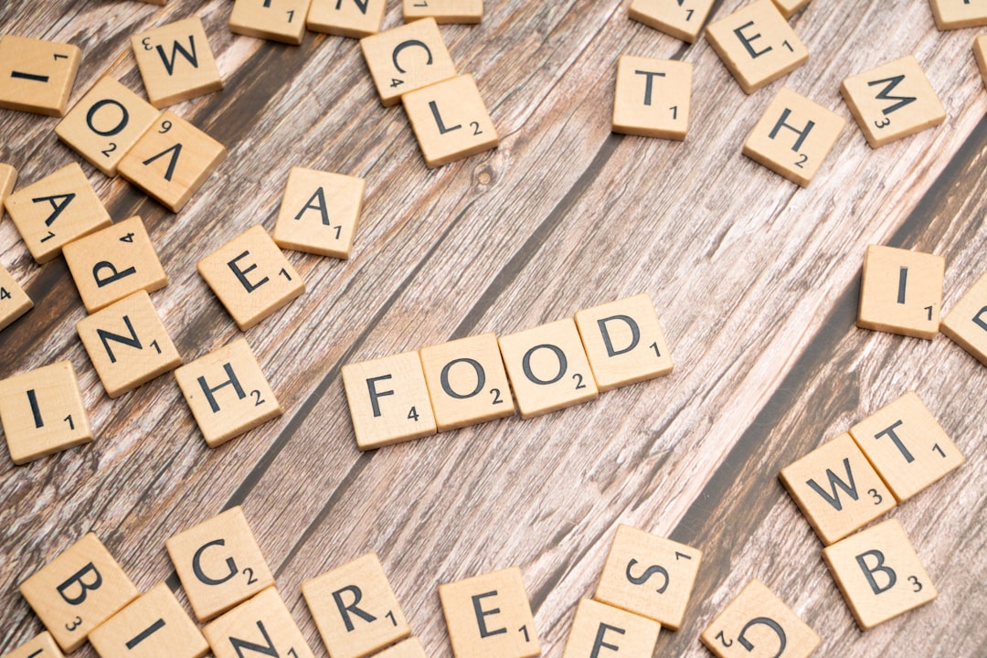 a close up of scrabble tiles on a wooden surface