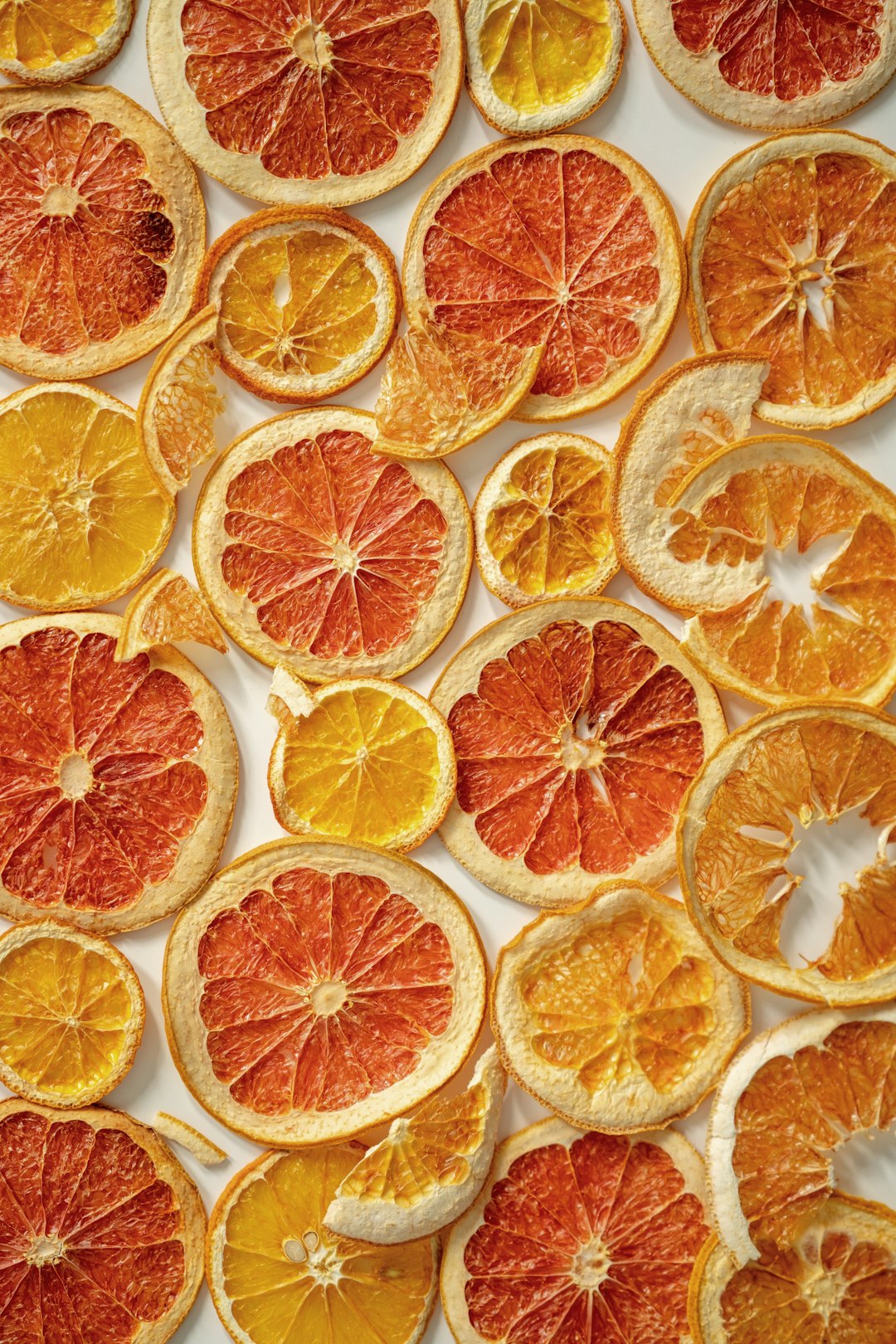 a bunch of oranges cut in half on a table